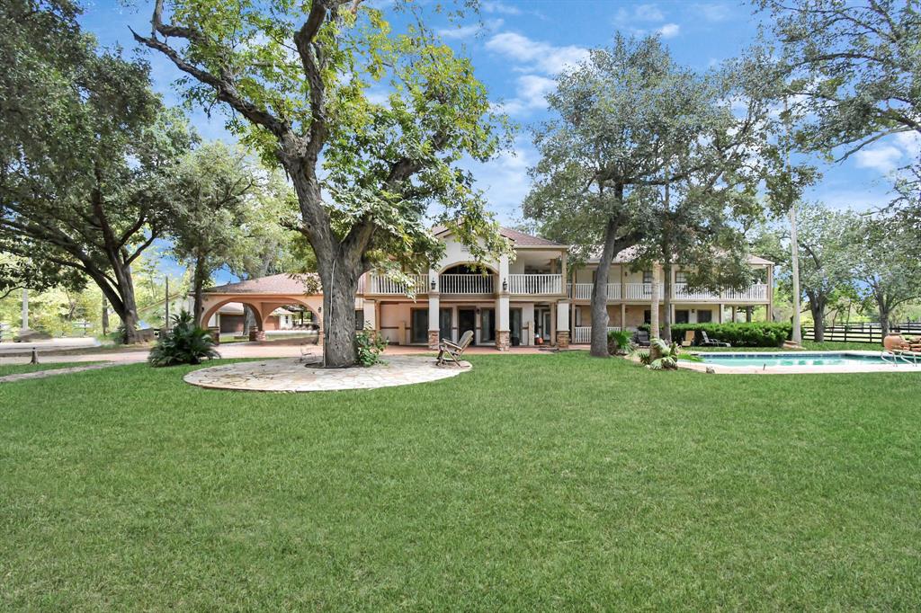 a view of a house with garden and trees