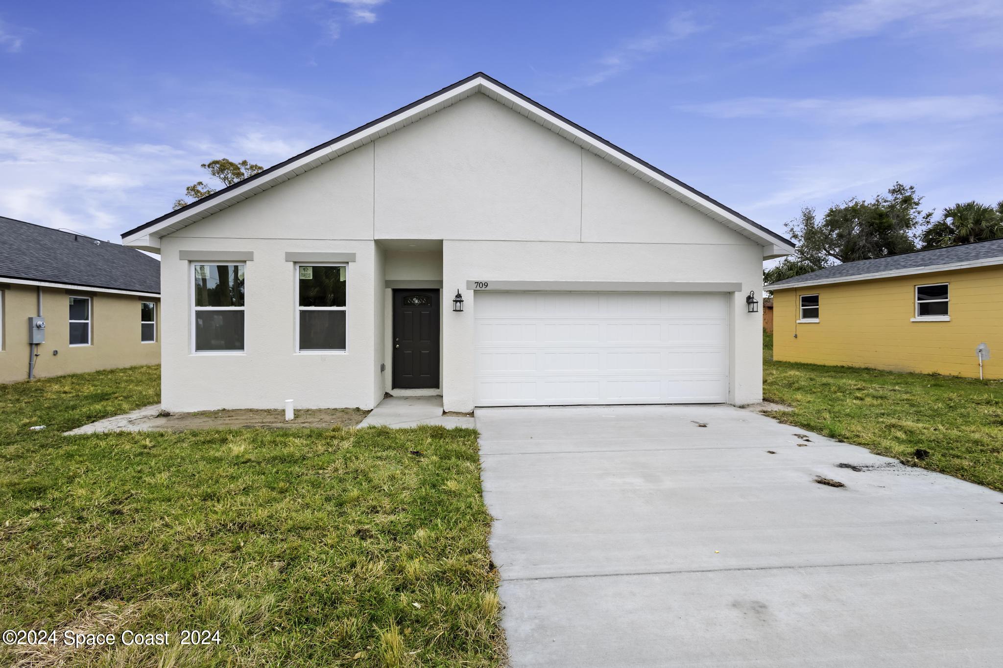 a view of backyard of house with garage