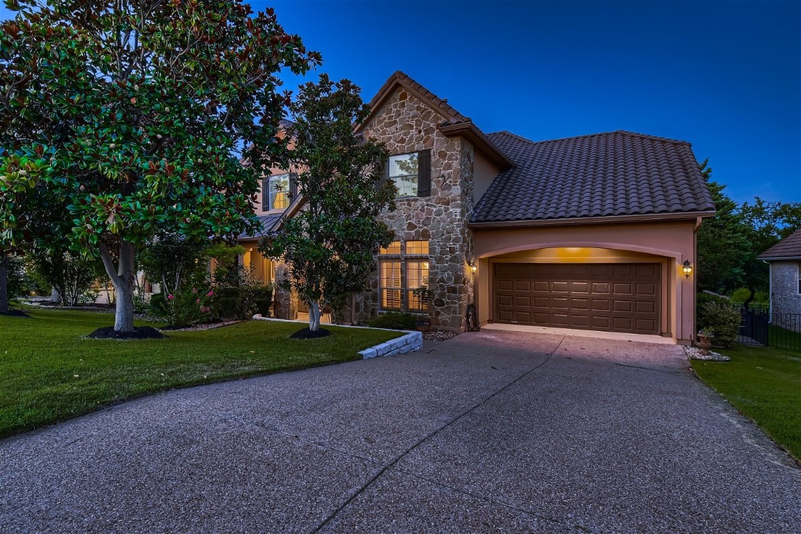 a front view of a house with a yard and garage