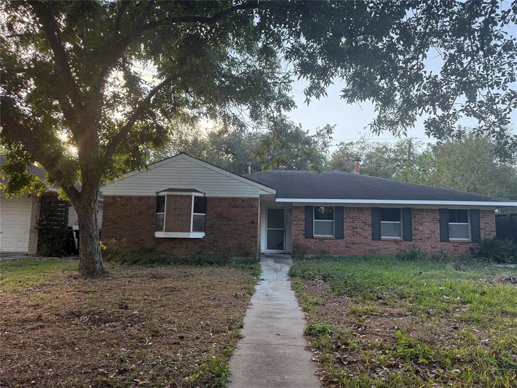 a front view of house with yard and trees