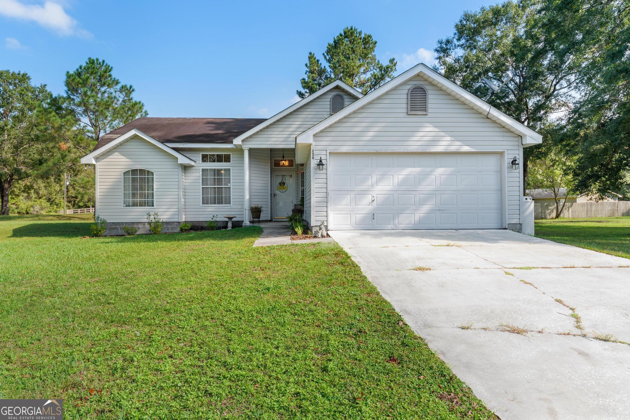 a front view of house with yard and trees