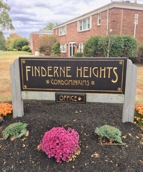 a sign broad in front of red brick house