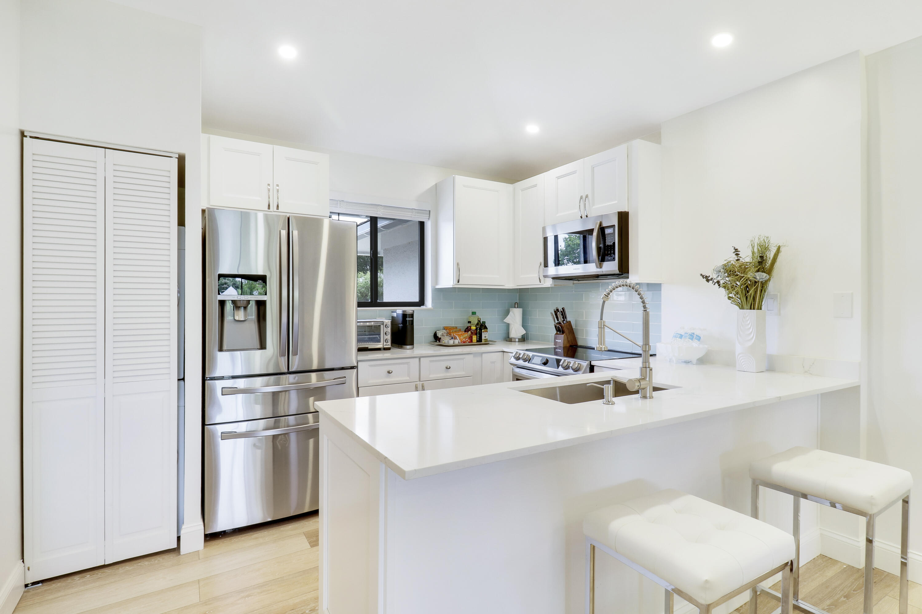 a kitchen with stainless steel appliances a refrigerator and a stove top oven