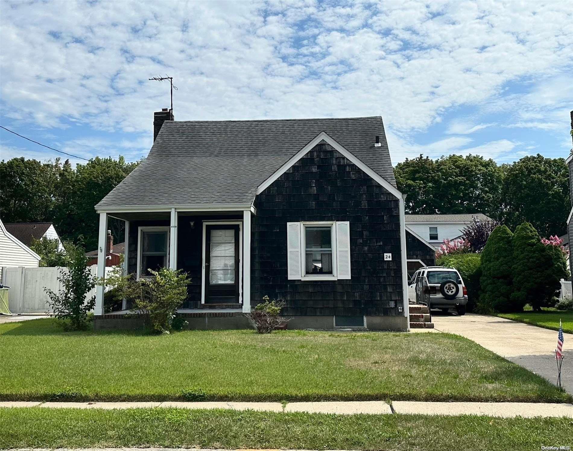 a front view of a house with a garden