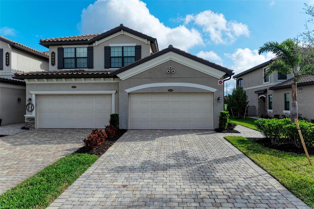 a front view of a house with a yard and garage