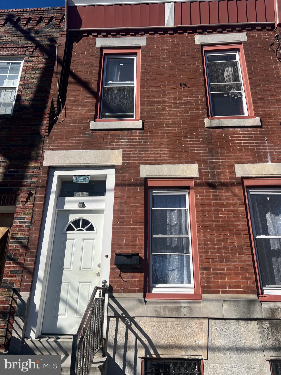 a front view of a house with large windows