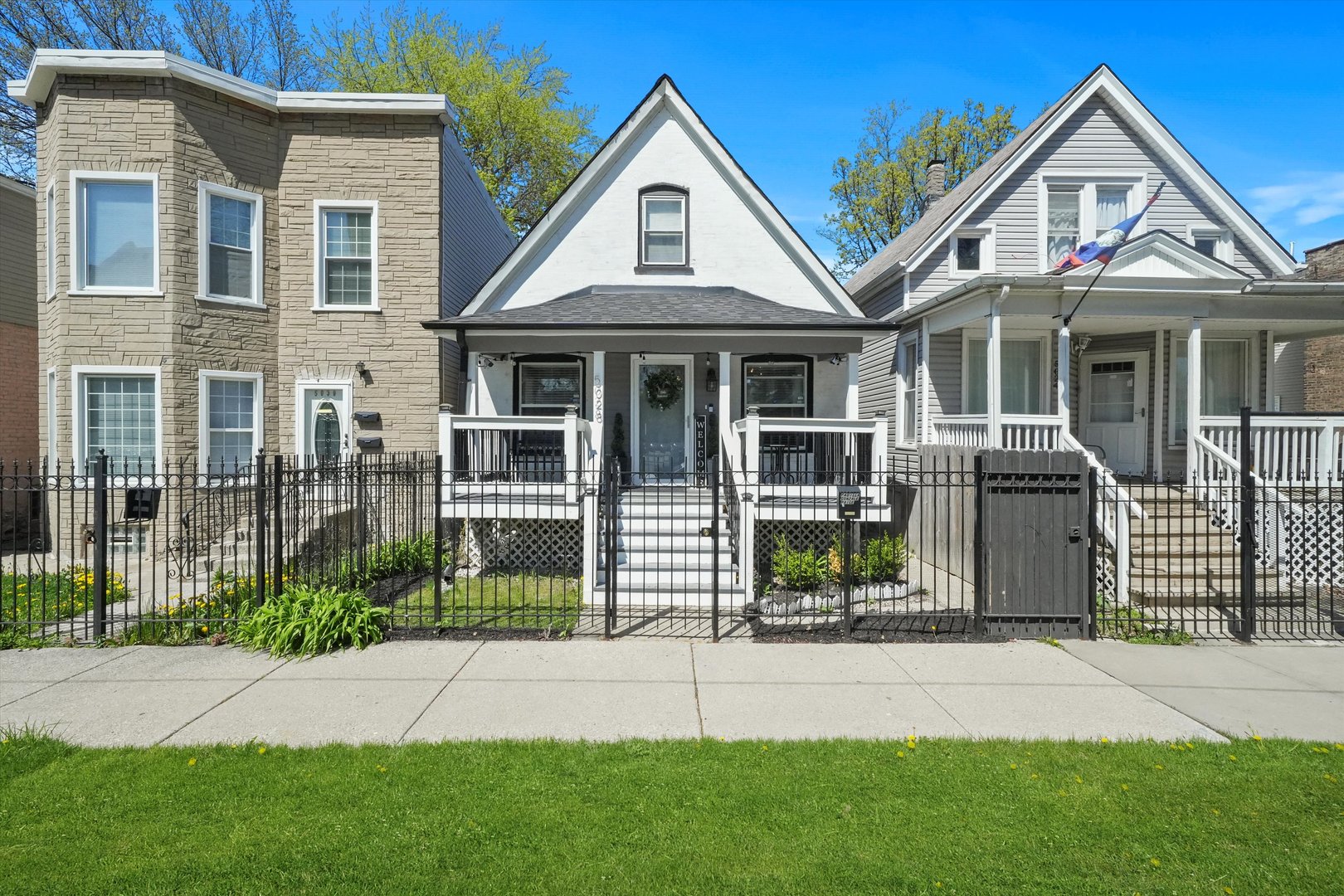 a front view of a house with a garden