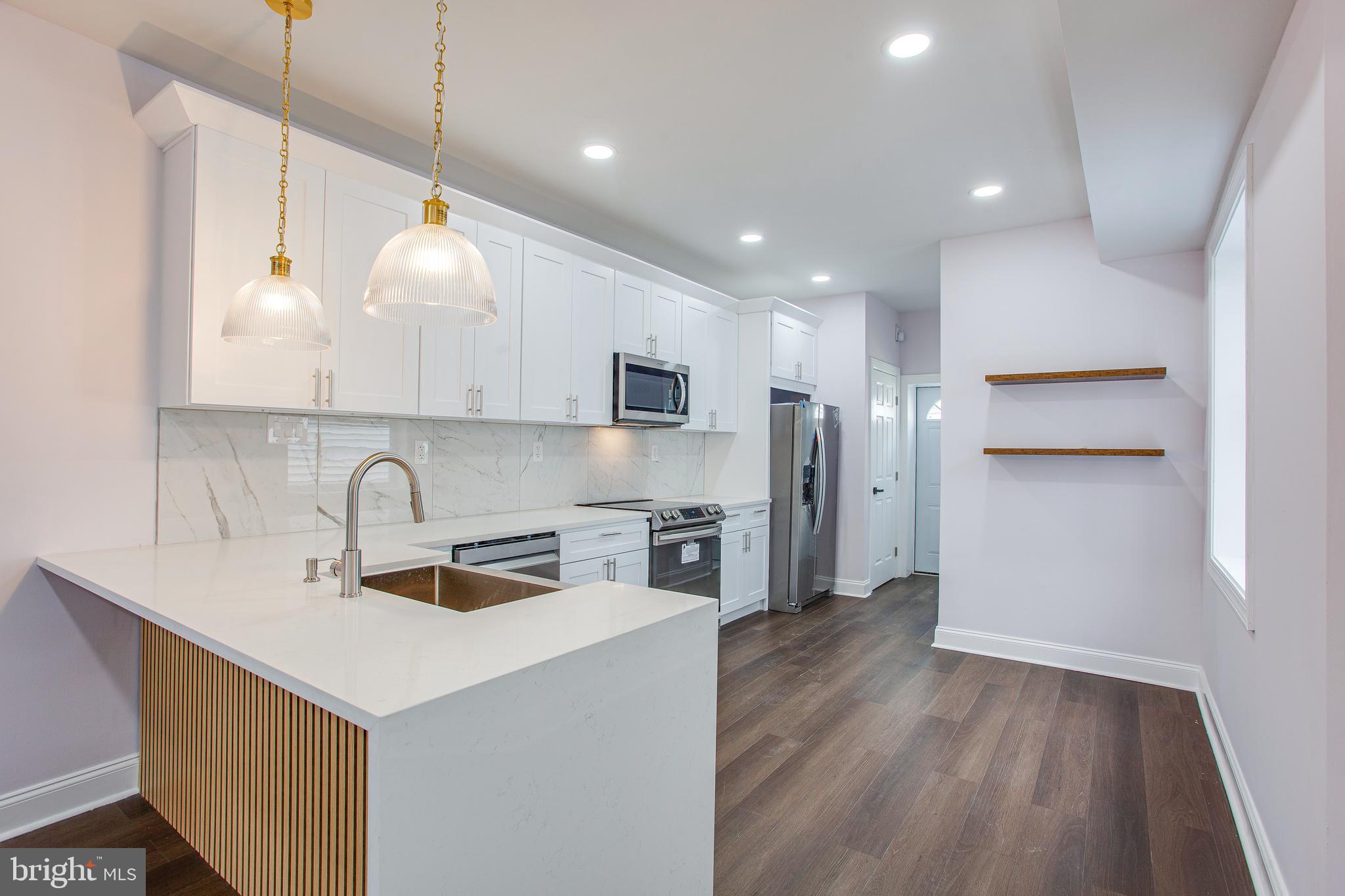 a kitchen with a sink stainless steel appliances and cabinets