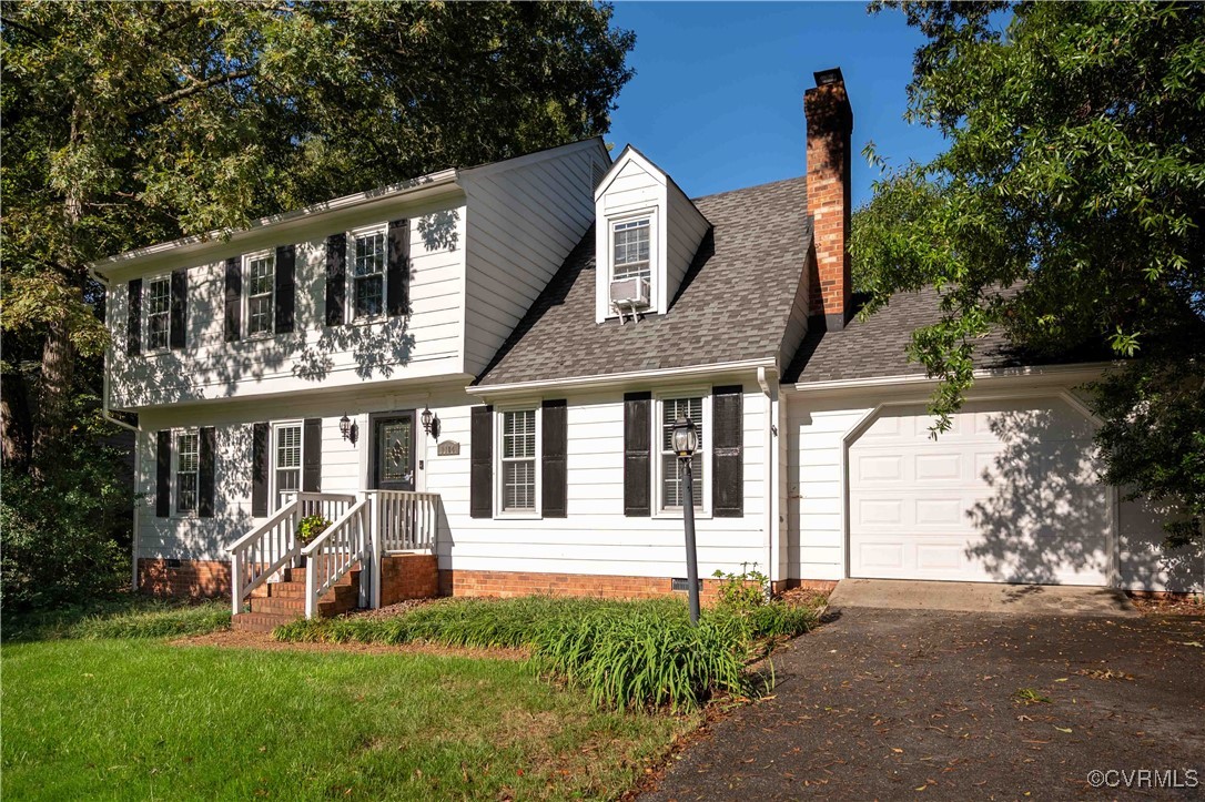 a view of a house with large trees and plants