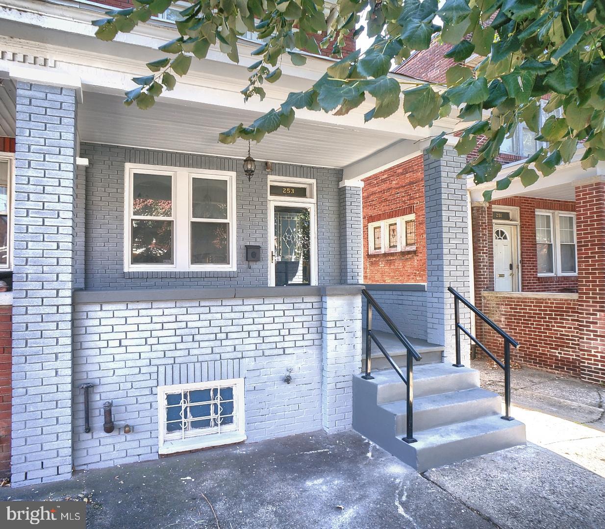 a view of a brick house with many windows