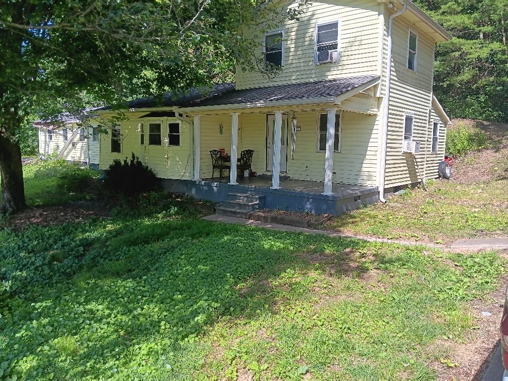 a view of a house with backyard and sitting area