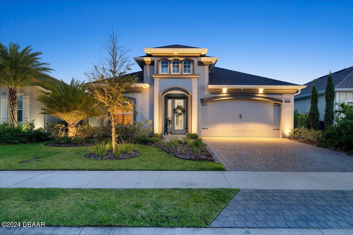 a front view of a house with garden