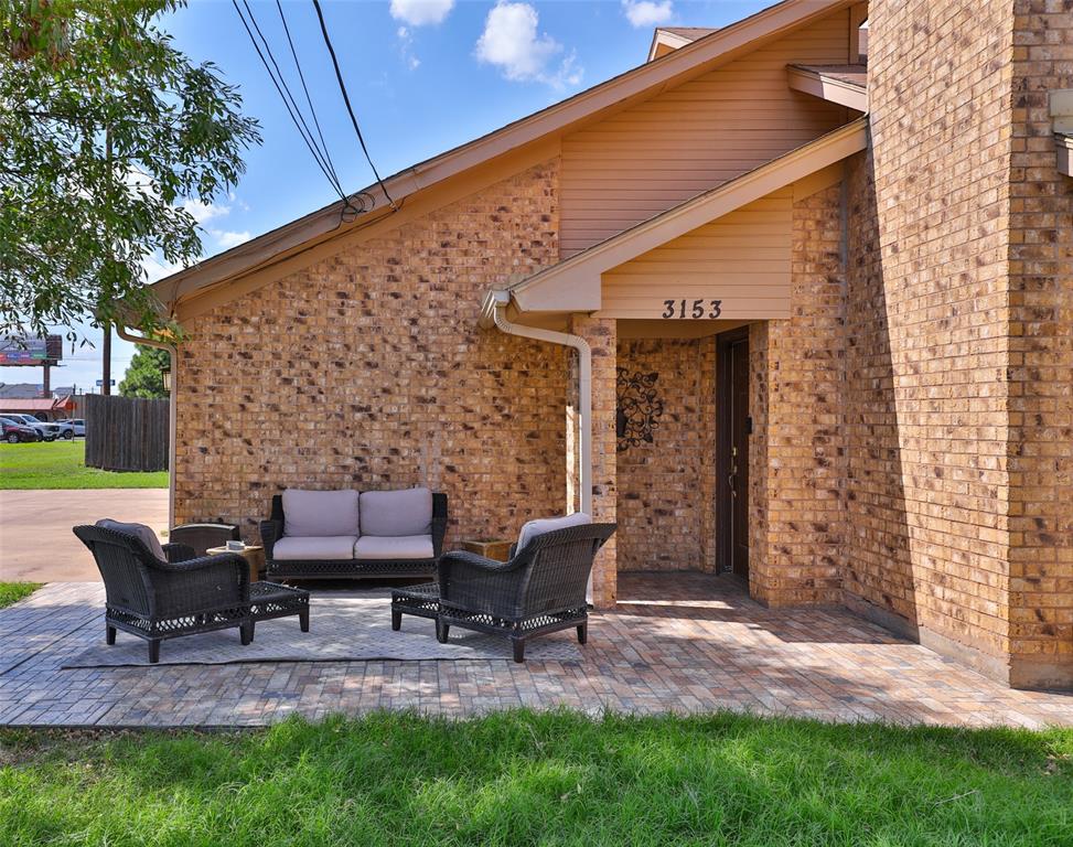 a backyard of a house with chairs and a fire pit