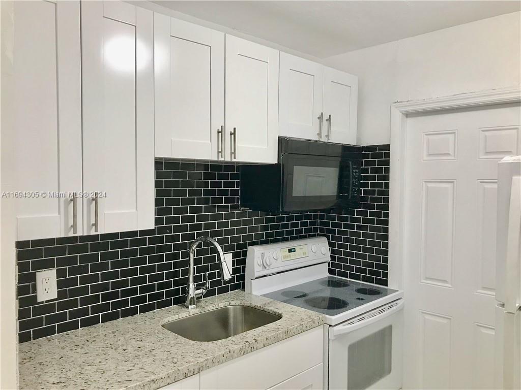 a kitchen with a sink stove and cabinets