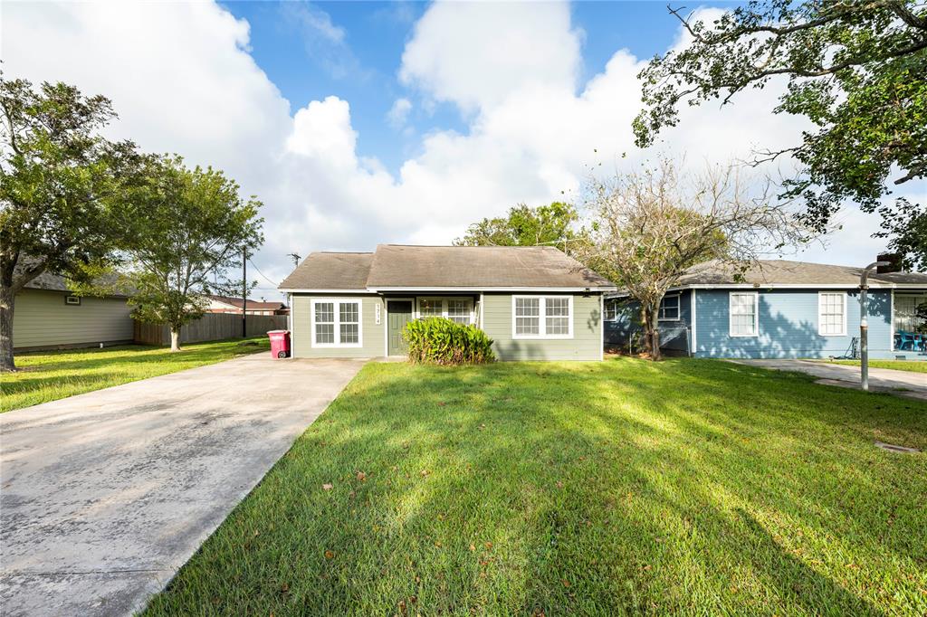 a front view of a house with yard and green space