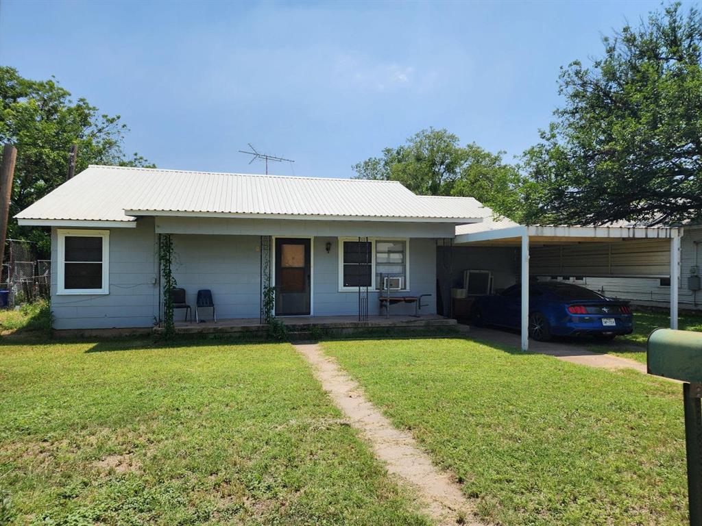 a view of a house with a yard and sitting area