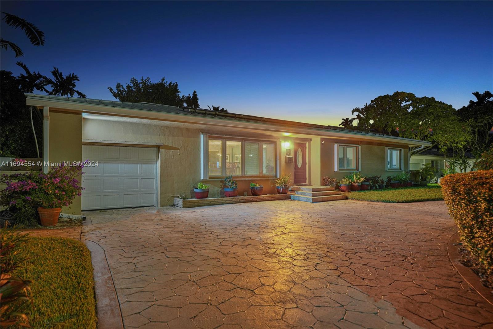 a view of a house with backyard and a garage