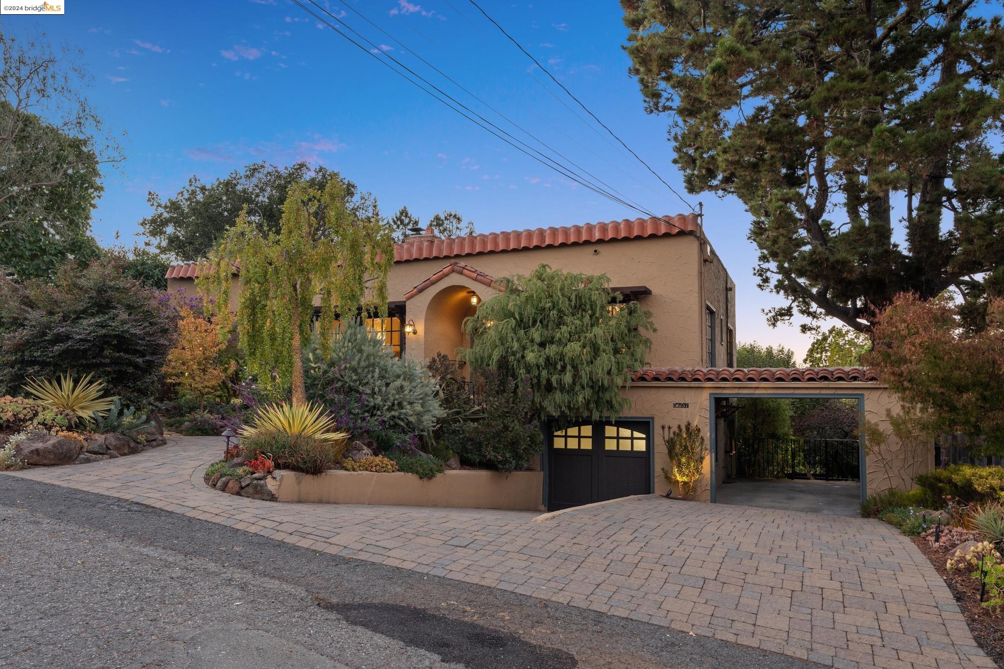 a front view of a house with a yard and a garage