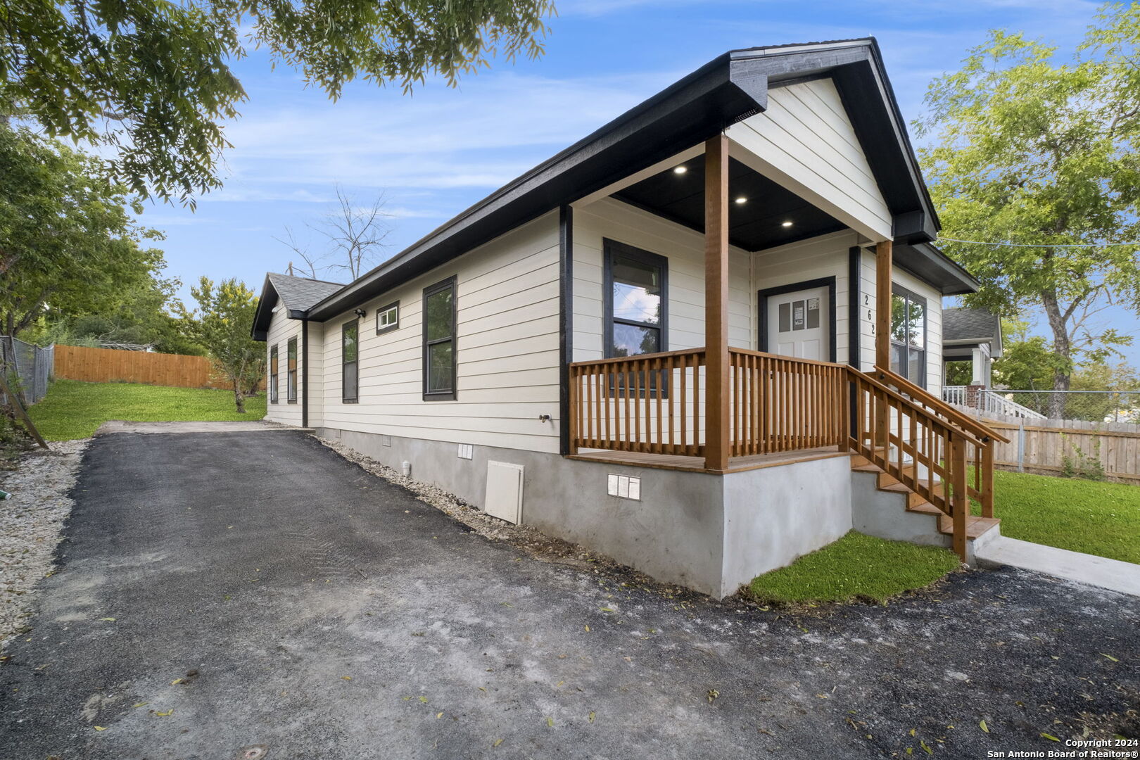 a view of a house with a yard porch and sitting area