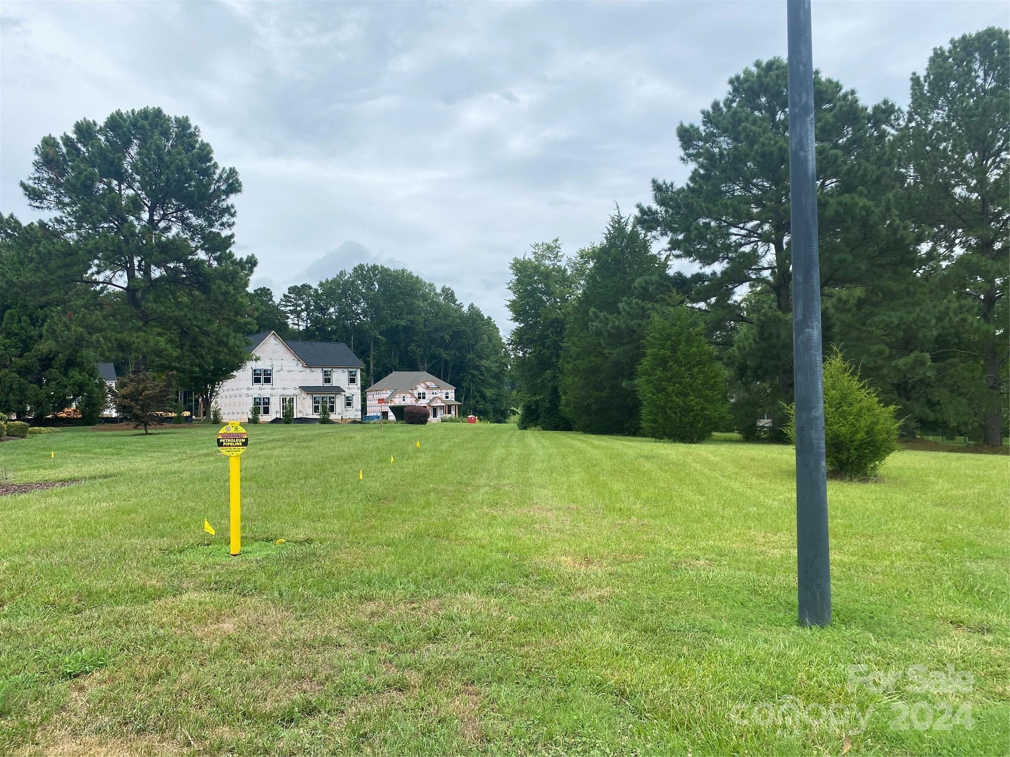 a house with a big yard and large trees