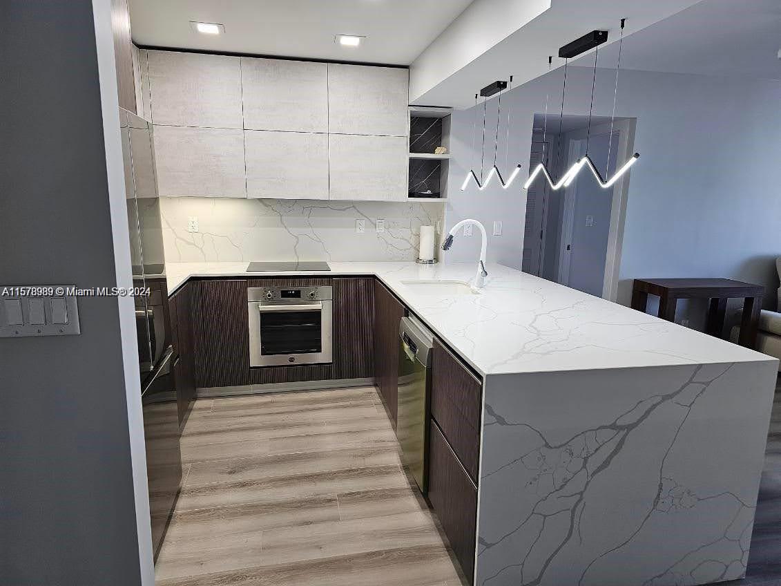 a kitchen with a sink a stove and cabinets