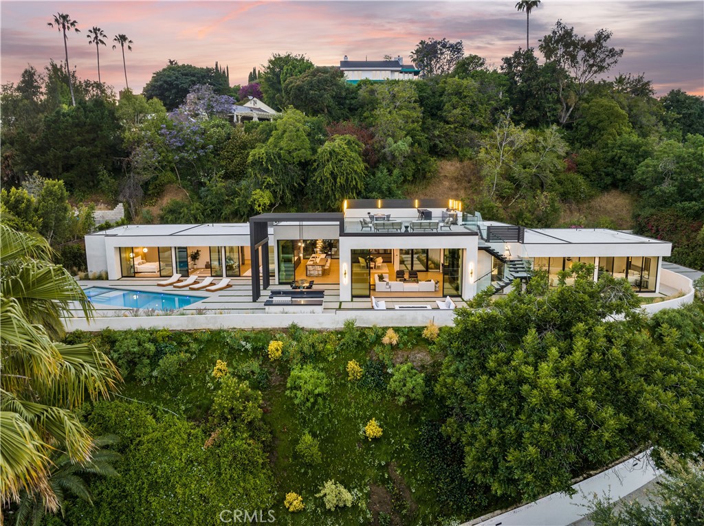 a view of a house with a yard and sitting area