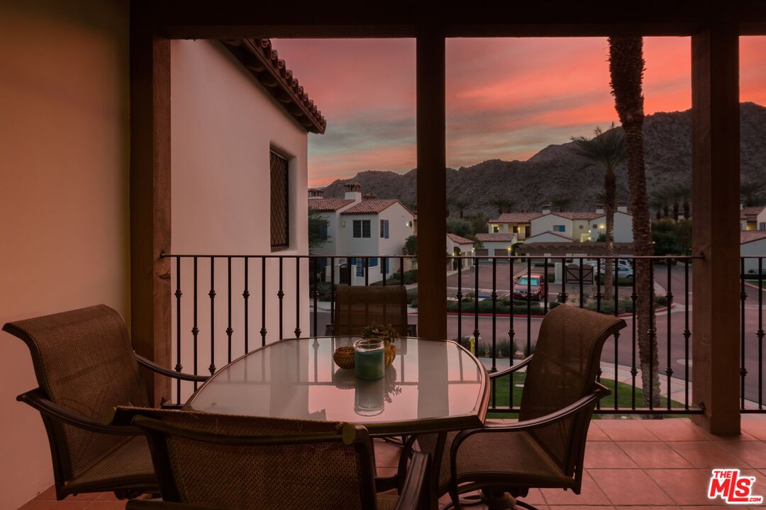 a view of a balcony with chairs