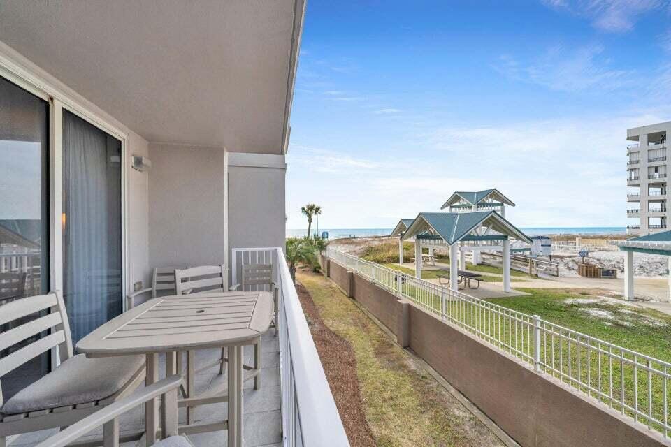 a view of a balcony with two chairs