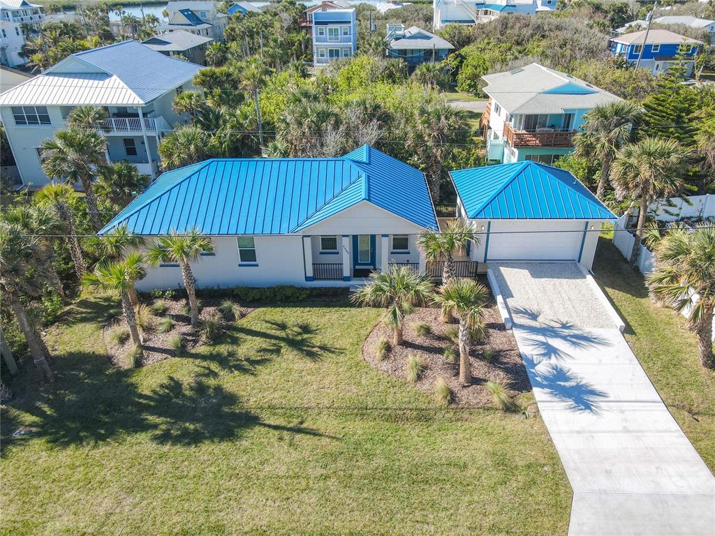 a aerial view of a house with swimming pool and sitting area