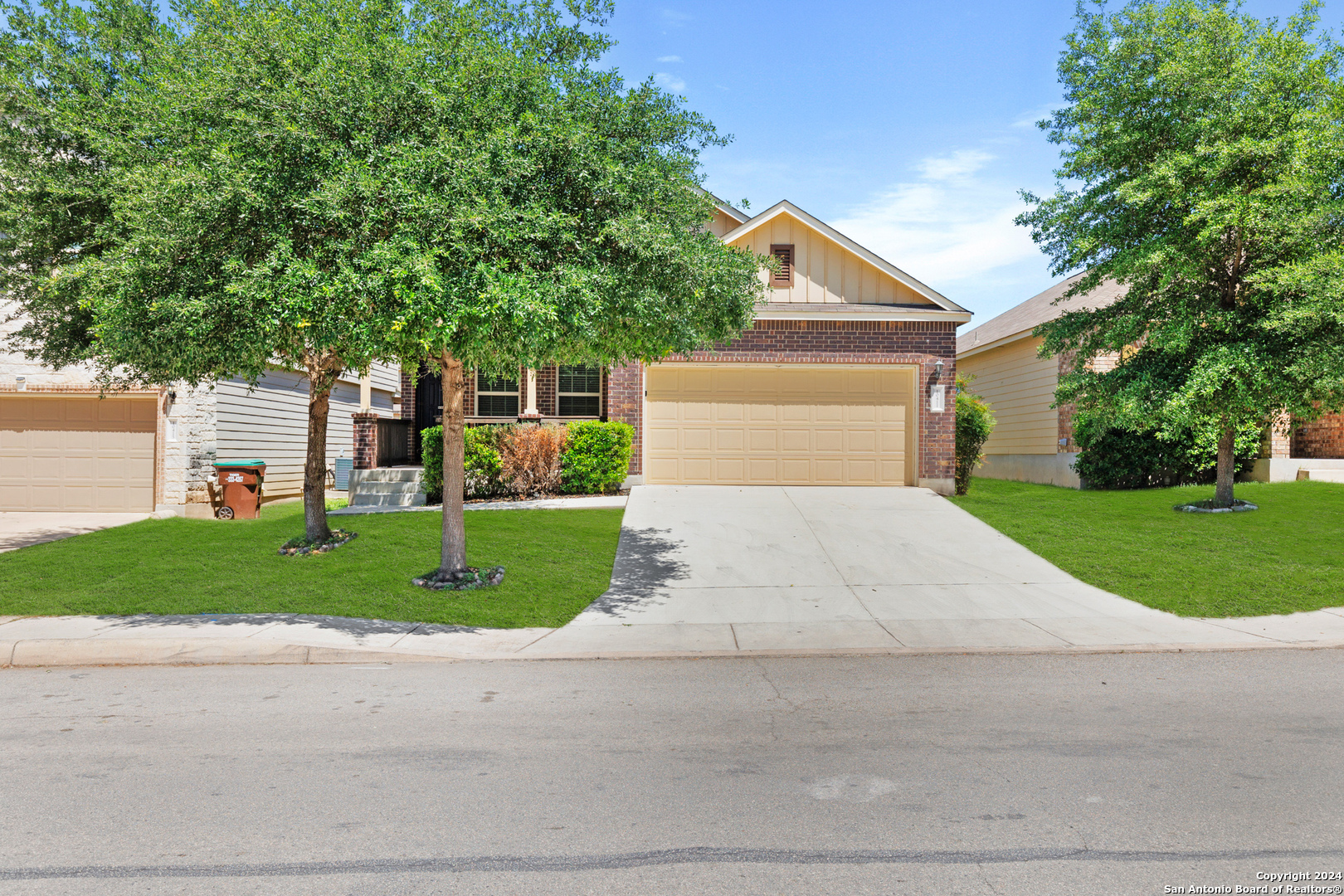 a front view of a house with a yard and garage