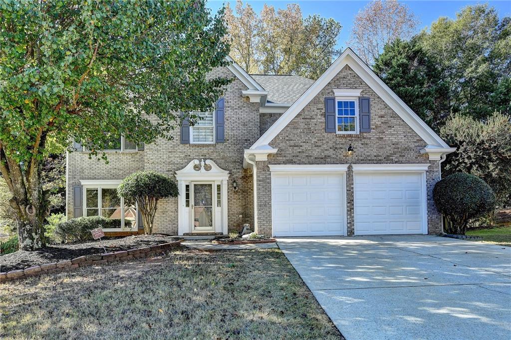 a front view of a house with a yard and garage