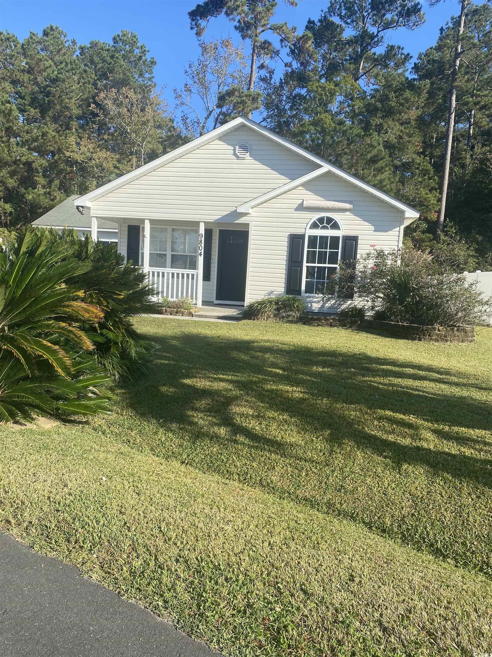 Ranch-style home with a porch and a front lawn