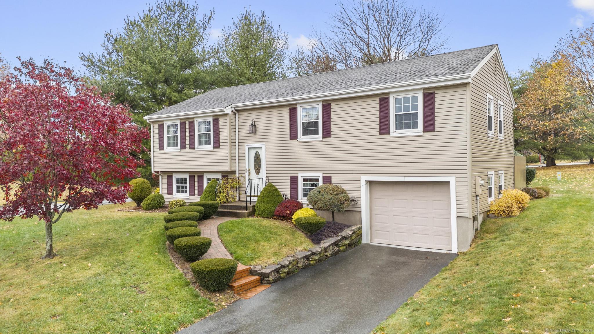 a front view of house with yard outdoor seating and green space