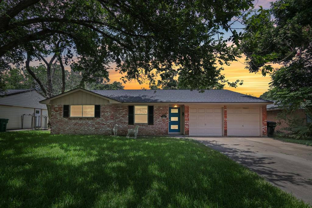 a house with green field in front of it