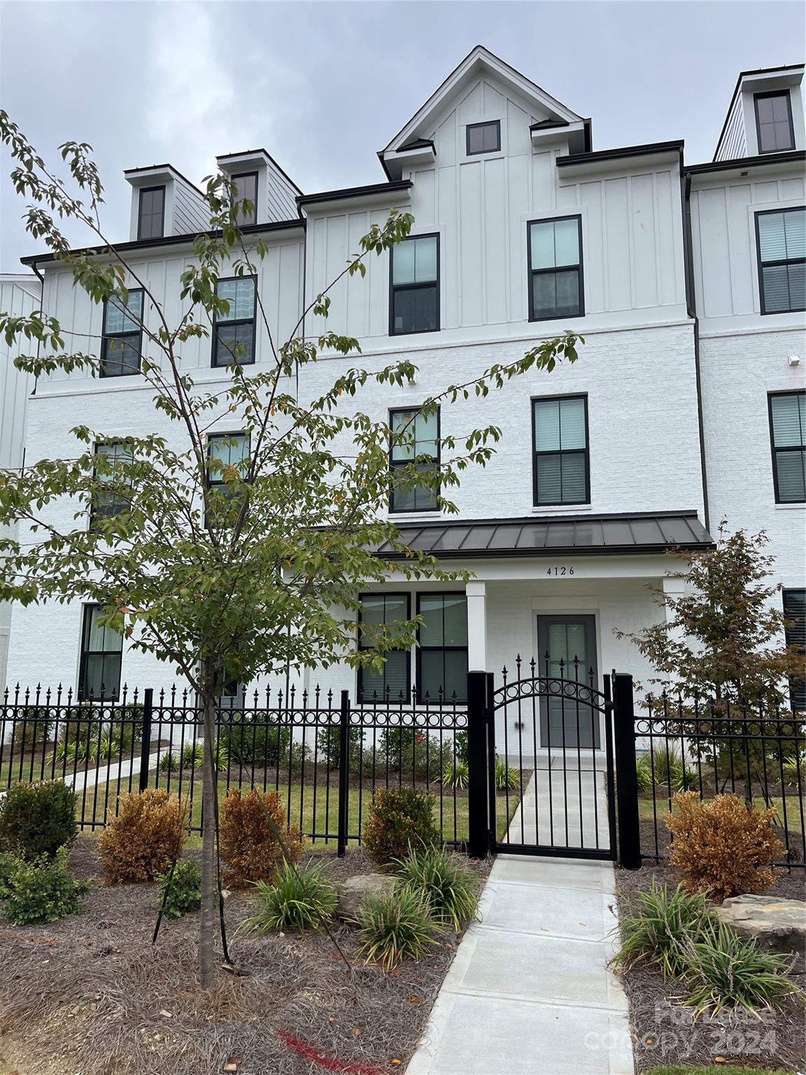 a front view of a house with garden