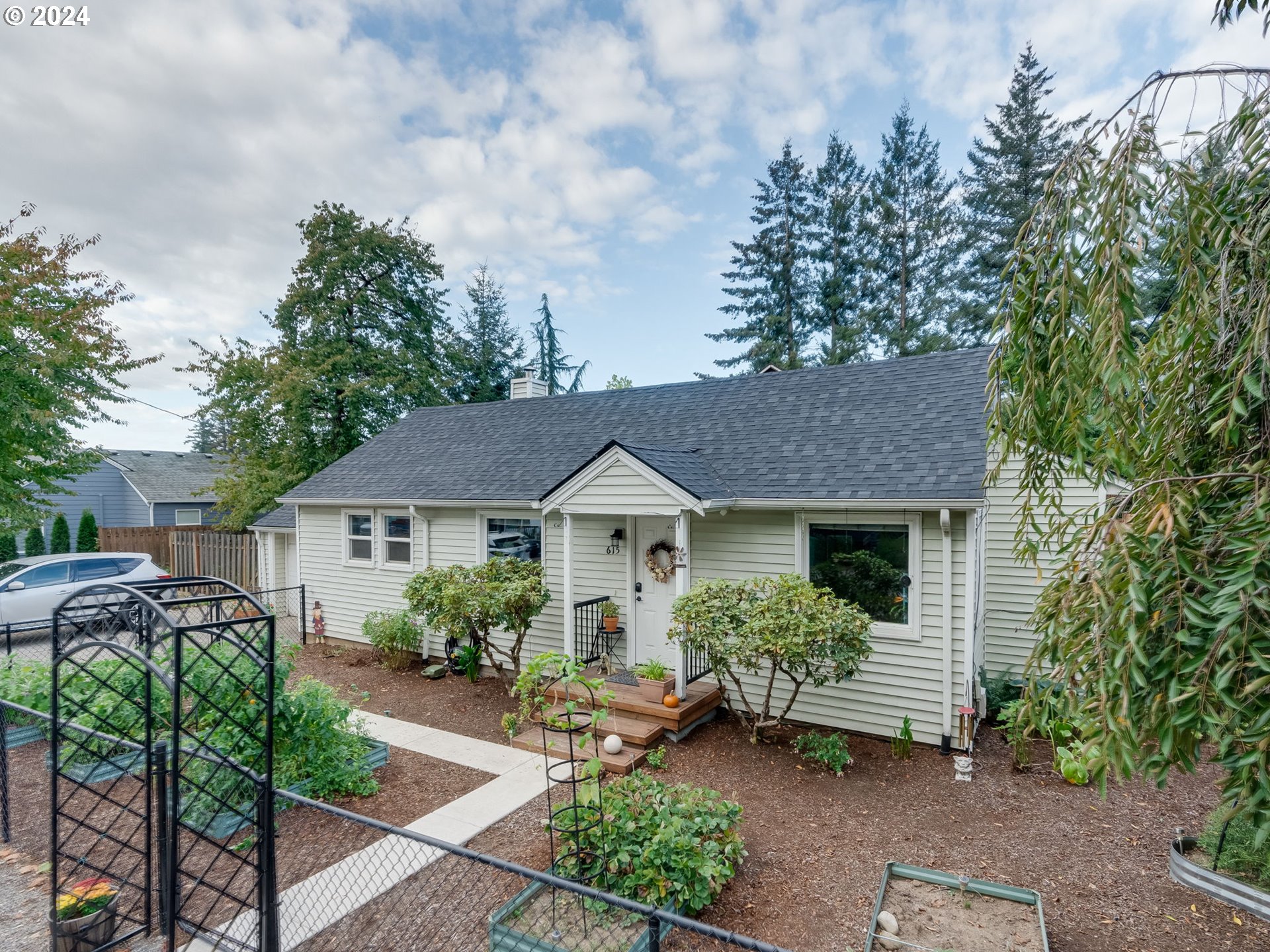 a view of a house with a small yard and plants