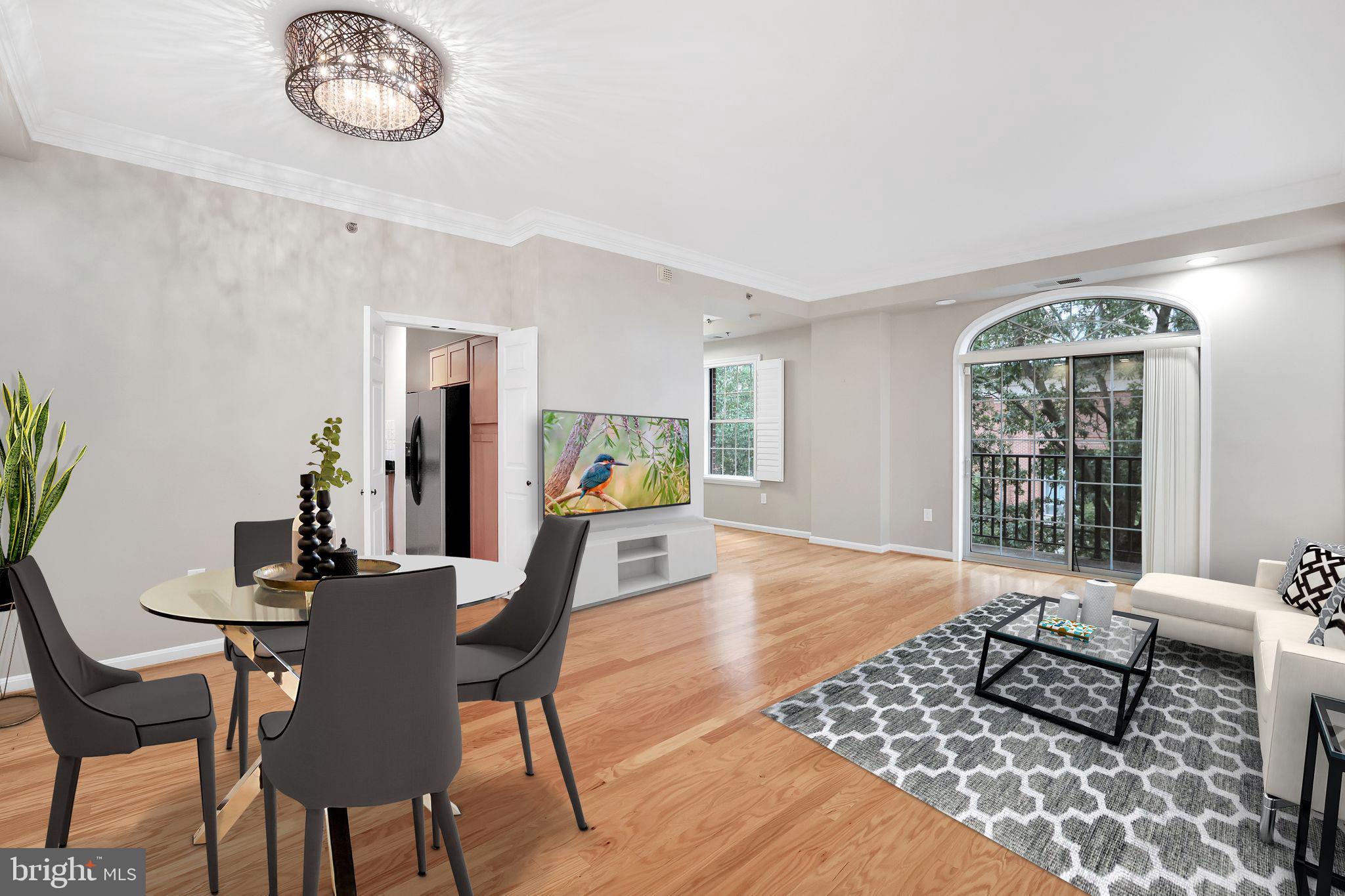 a dining room with furniture a rug and a large window