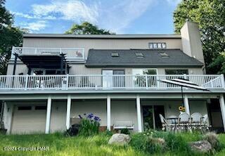 a front view of a house with balcony and garden