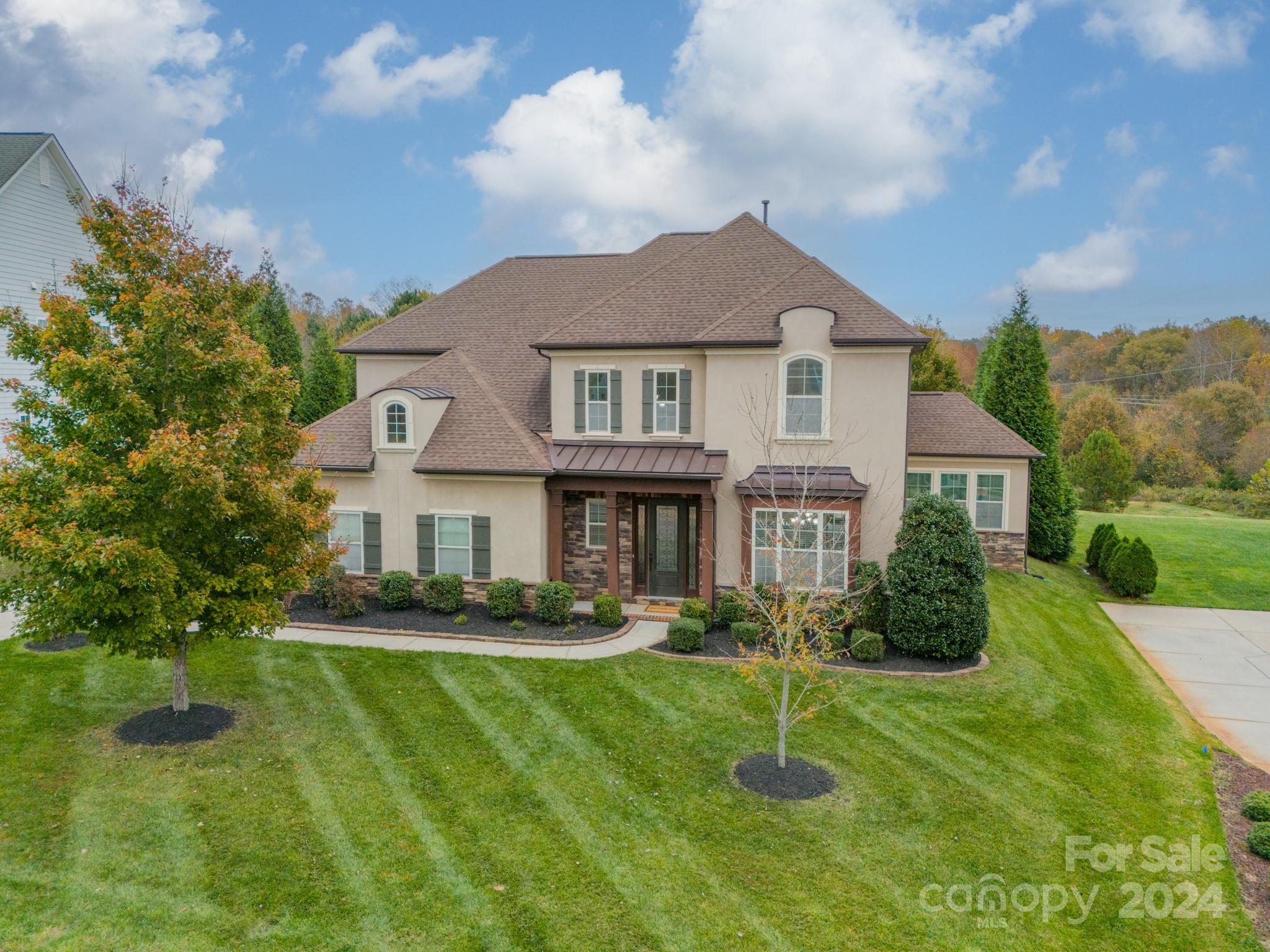 a front view of a house with a yard