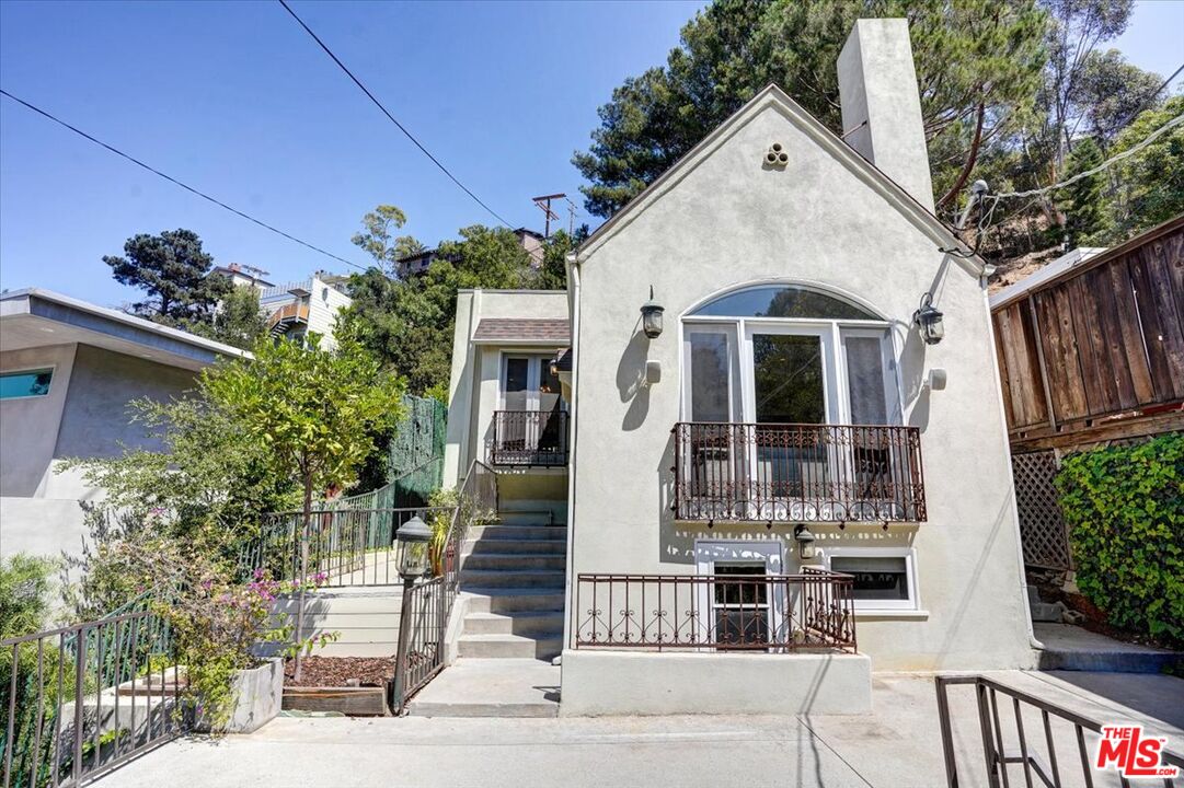 a front view of a house with plants