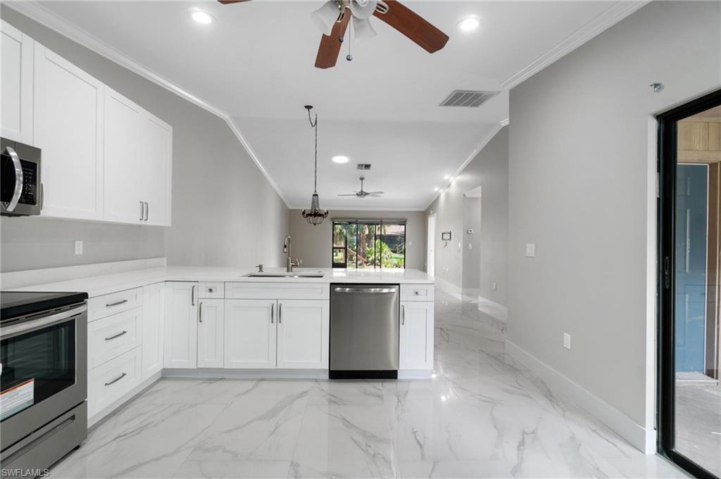 a kitchen with a white stove sink and cabinets