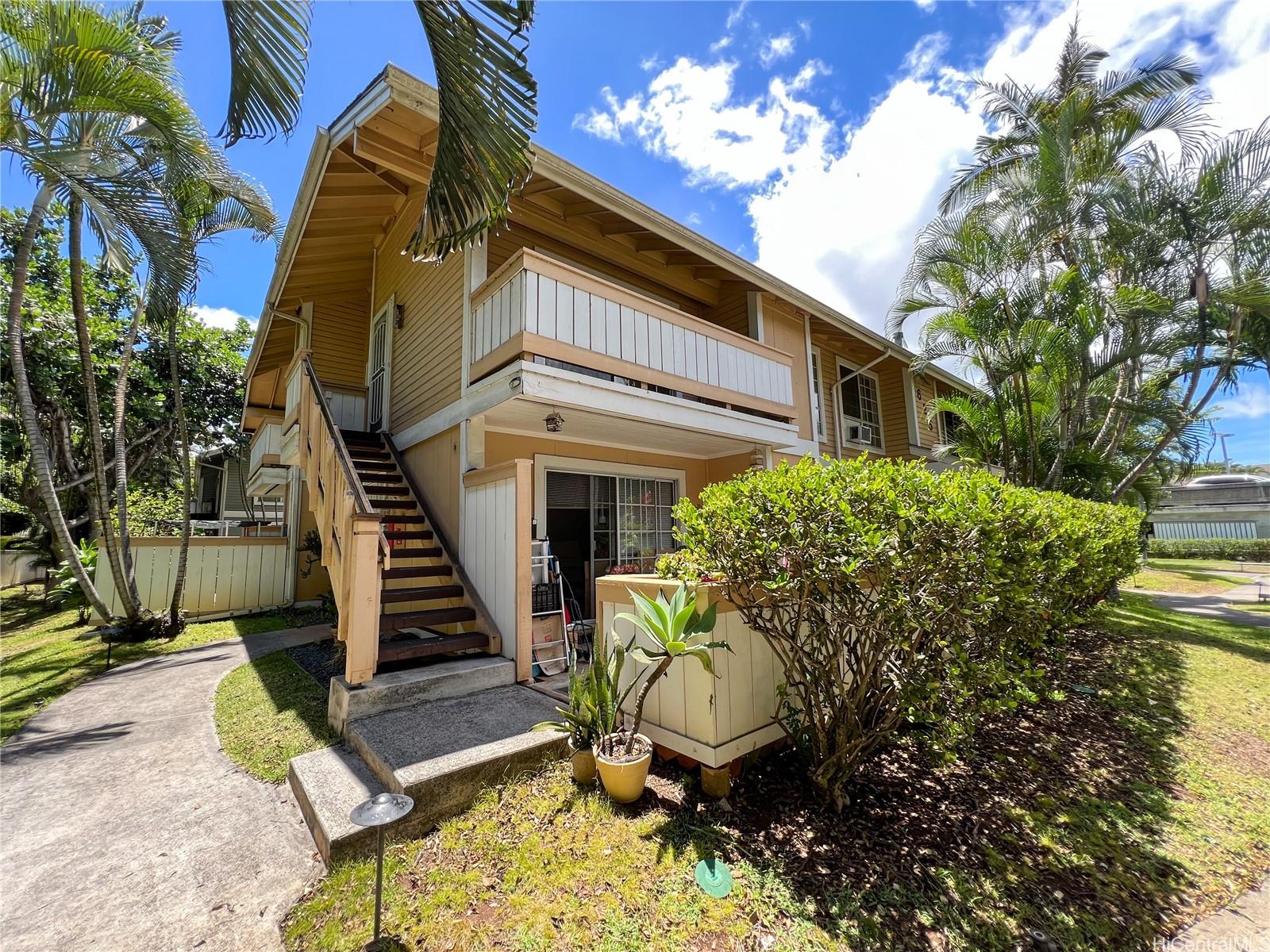 a view of a house with backyard and sitting area