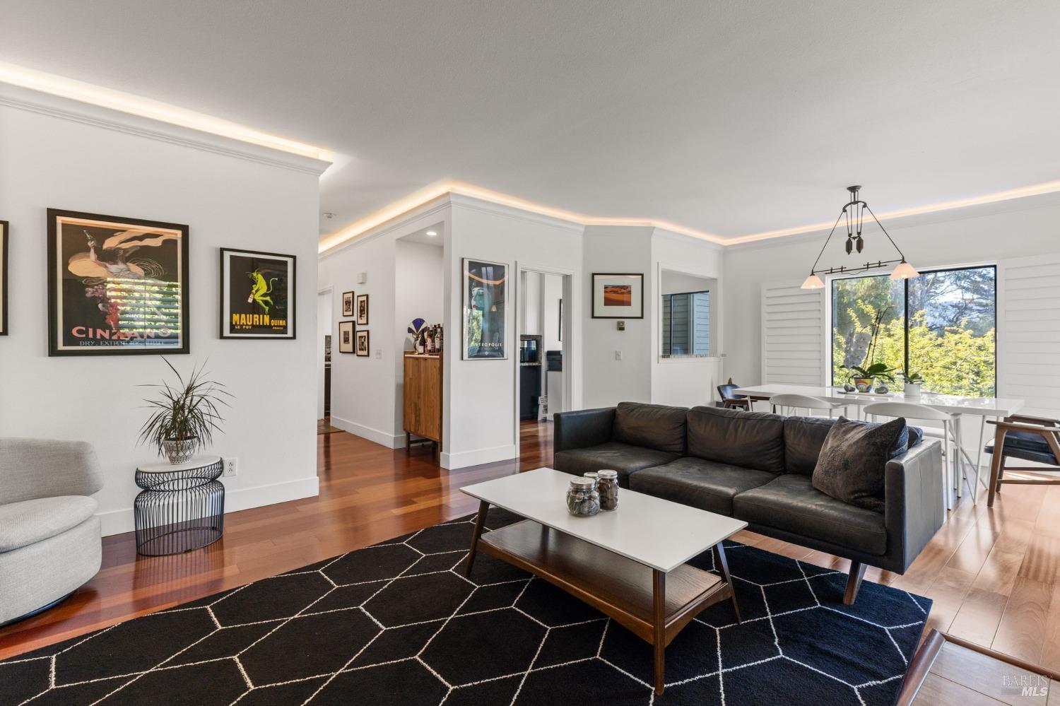 a living room with furniture a dining table and a large window