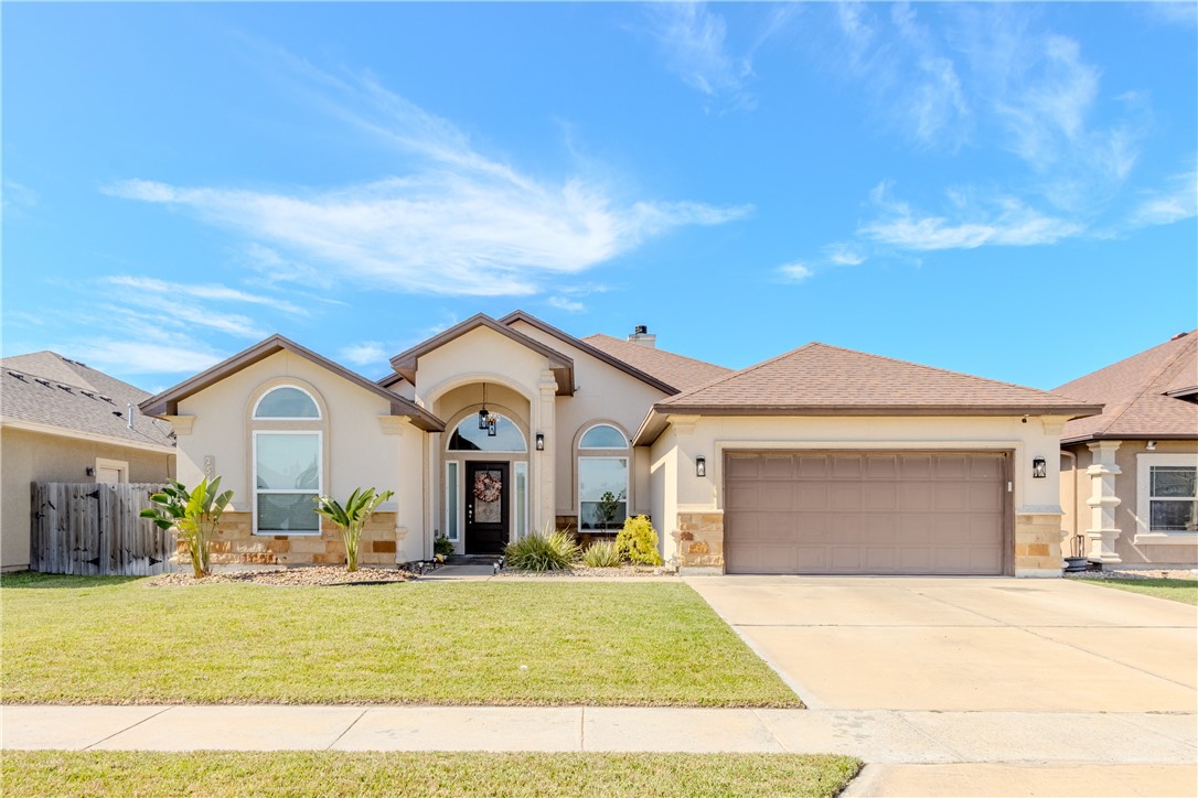 a front view of a house with a yard