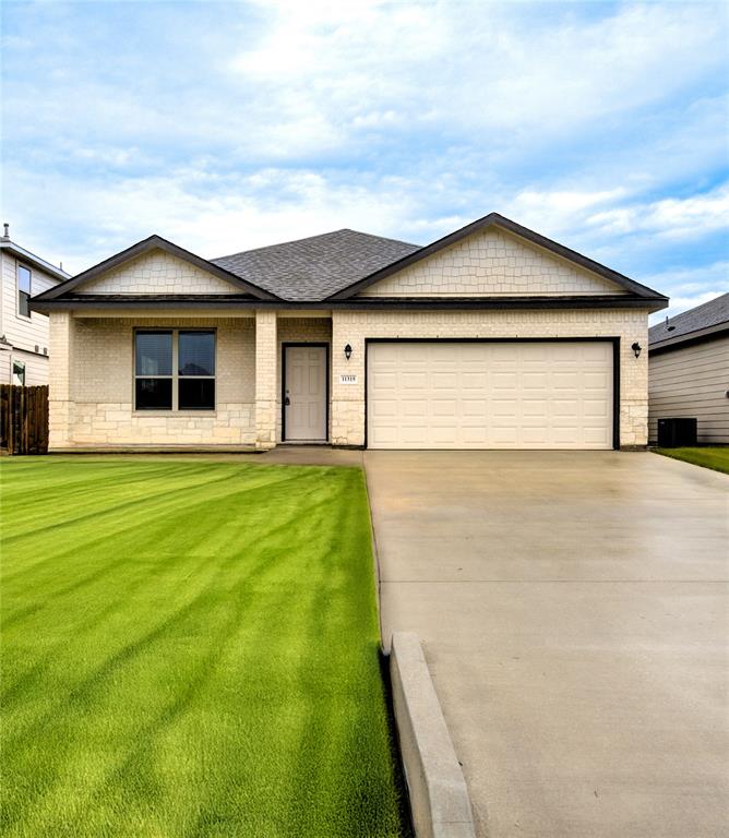 a front view of house with yard and green space