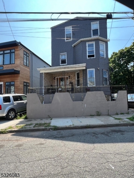 a front view of a house with garage and sitting area