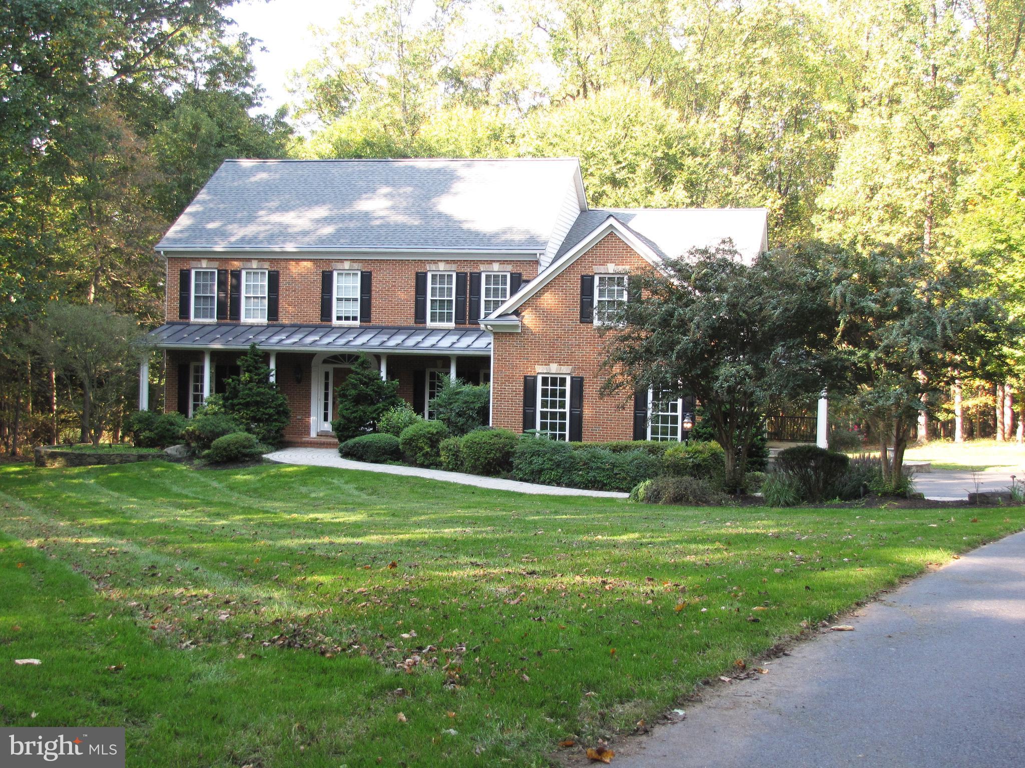 a aerial view of a house next to a big yard and large trees