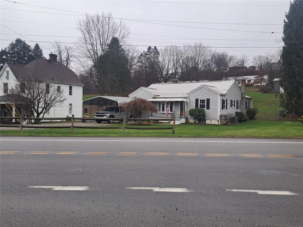 a view of multiple houses with yard and green space