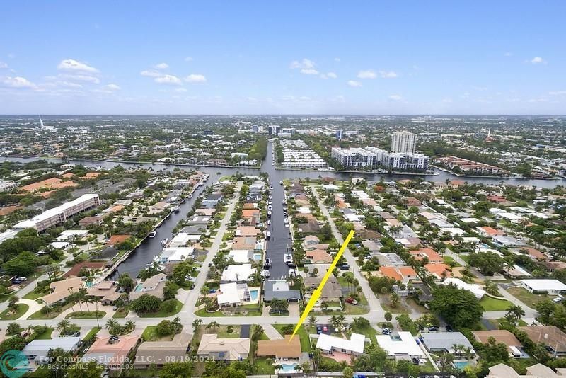 an aerial view of residential houses with city view