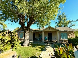 a front view of a house with yard outdoor seating and garage